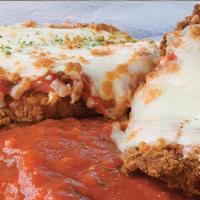 Mio Figliolo (Veal Parmigiana) · Breaded veal cutlet topped with marinara and mozzarella, served over pasta marinara