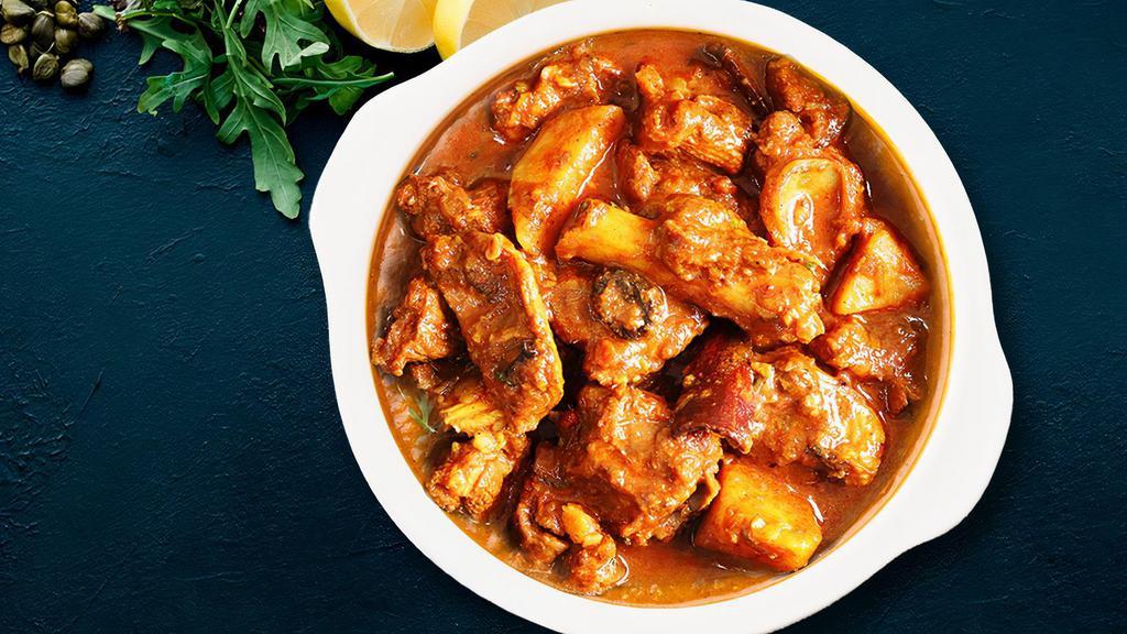 Goat Vindaloo · Goa’s favorite dish. Goat chunks cooked with dry red chili, garlic, baby aloo, white vinegar and spices.