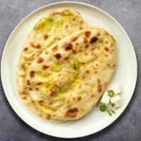 Fire Bender Naan · Freshly baked bread in a clay oven then coated in garlic.