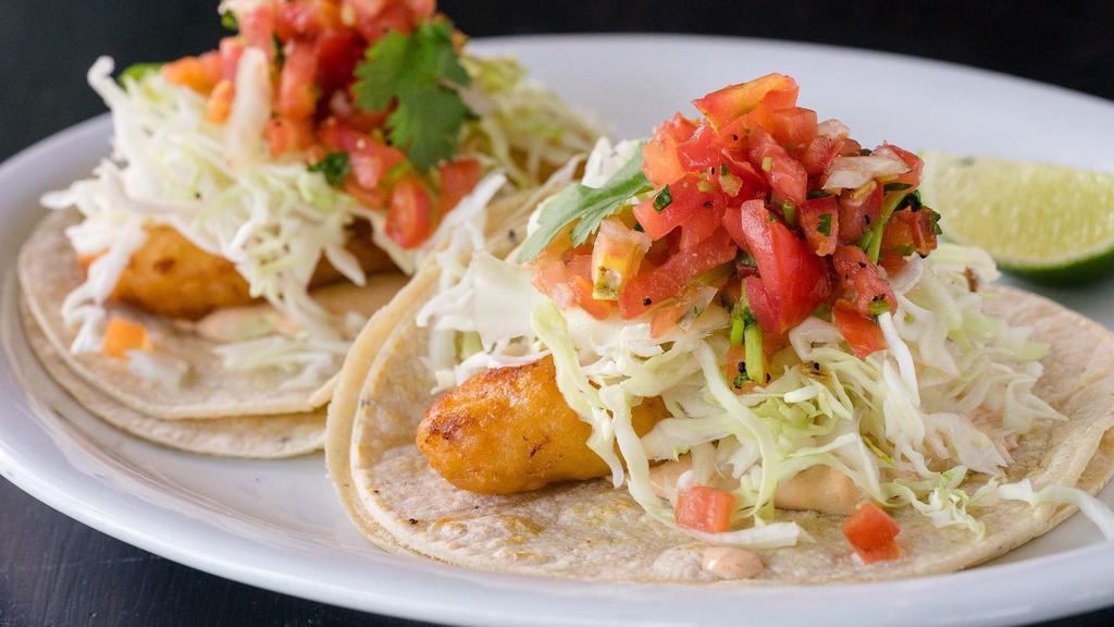 Baja Taco · fried fish with chipotle crema, cabbage cilantro, salsa fresca, and lime