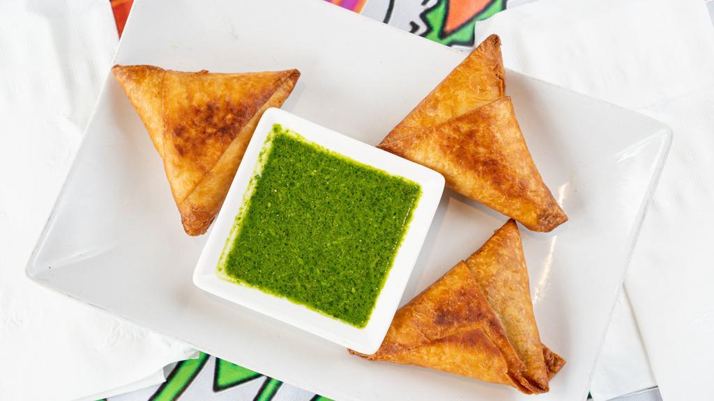 Samosa (Beef) · Triangles shaped pastry shells (made in-house by lemat) stuffed with minced beef, onion jalapeño and fine herbs. This dish is lightly deep fried in vegetable oil to golden perfection.