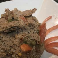 Timatim Fitfit · Roll of injera scrambled in a blend of fresh tomato, jalapeños spring onions, lime juice and...