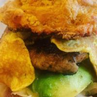 Sausage and Biscuit Breakfast Sandwich · Egg, sausage, avocado, and cabbage slaw on a cheddar chipotle biscuit.