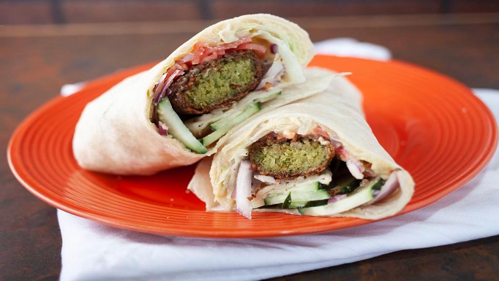 Falafel Sandwich (Vegetarian) · Fresh Falafel served on a wrap with Hummus, lettuce, tomatoes, cucumbers, onions and pickles.