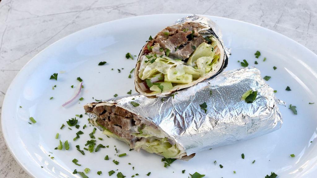 Lamb and Beef Gyros Wrap · Slow-cooked, thin-sliced, marinated lamb and beef, served on lavash bread with lettuce, tomatoes, cucumber, onions and yogurt sauce.