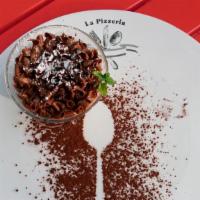 Chocolate Mousse · Topped with  chocolate curls with a heart of zabaglione