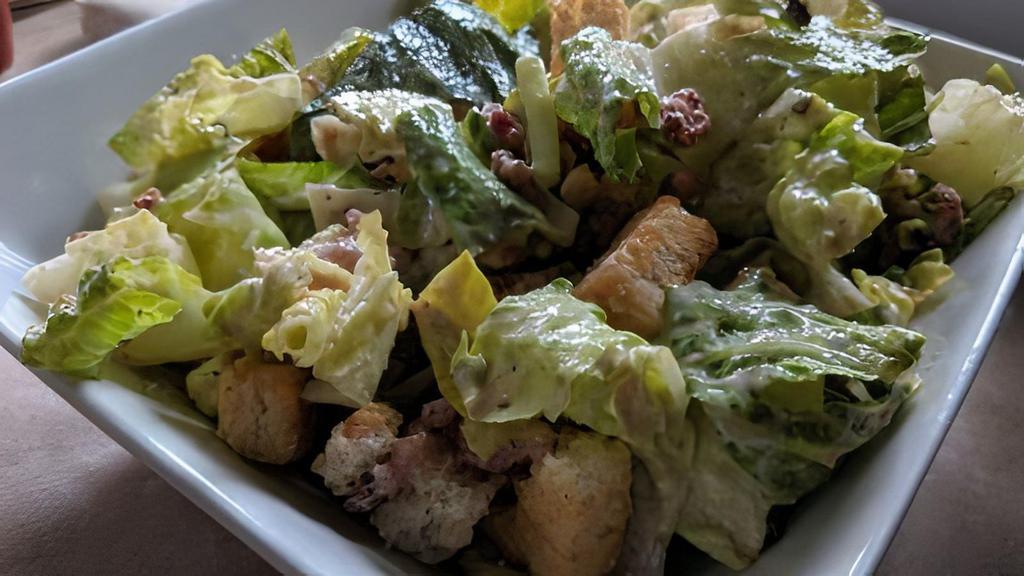 Chicken Caesar · Warm slices of grilled chicken, romaine hearts, parmesan cheese & croutons. Tossed in (anchovy-free) caesar dressing