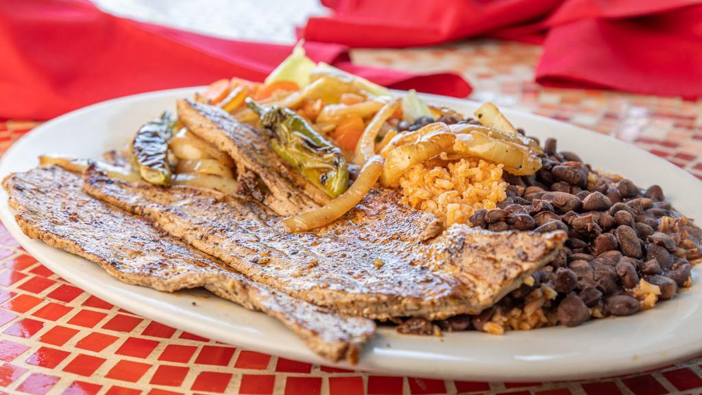 Carne Asada Platter · Grilled steak topped with salsa ranchera served with rice black beans and vegetables.