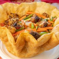 Tostada Salad · A large pour tortilla bowl filled with grilled chicken or steak on top of a bed of lettuce, ...