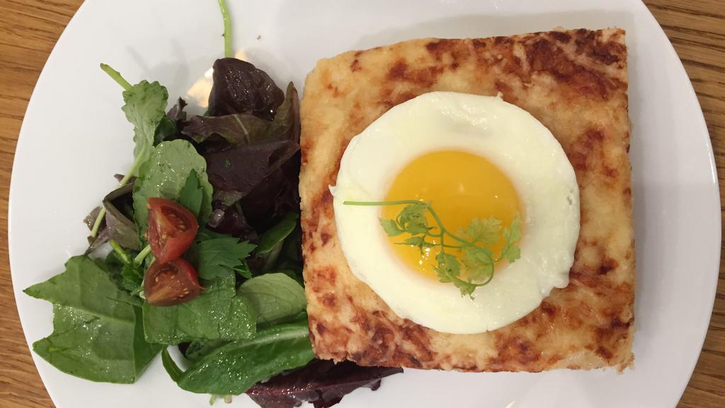 Croque Madame · French style Croque Monsieur prepared with Maison Alyzee brioche bread, emmental cheese, shredded cheese, morney sauce, French ham (Jambon de Paris) & one sunnyside egg. Served with green salad & cherry tomatoes.