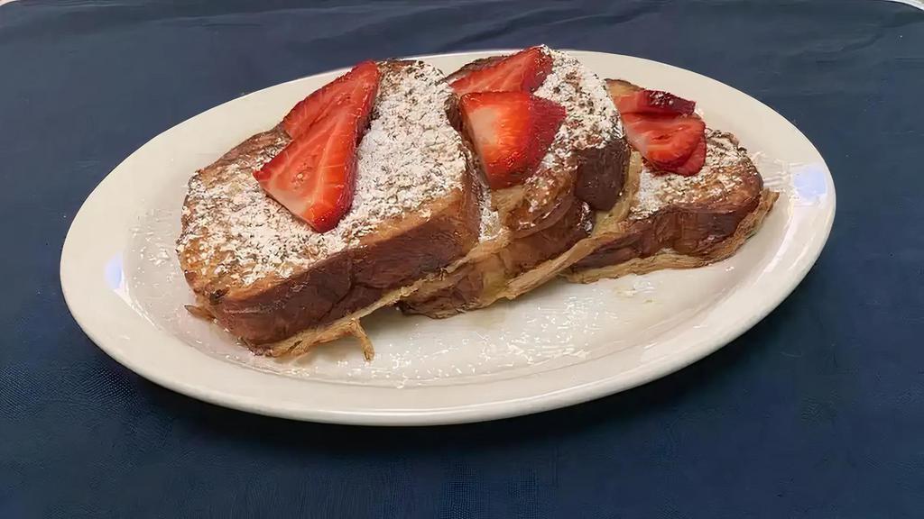 Challah French Toast · Three cinnamon twist challah French toast with powdered sugar, syrup and butter