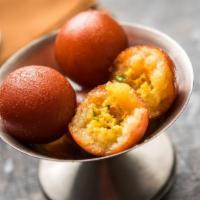 Gulab Jamun · Two pieces traditional donut holes served in a sweet rosewater syrup.
