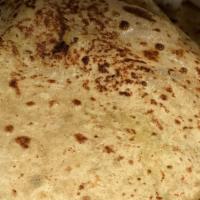 Aloo Paratha · Whole wheat bread stuffed with spiced potatoes & peas.