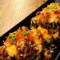 Volcano Roll · Deep Fried Tuna Maki Topped with Baked Snow Crab Meat, Spicy Aioli, Soy Glaze, Cheese and To...