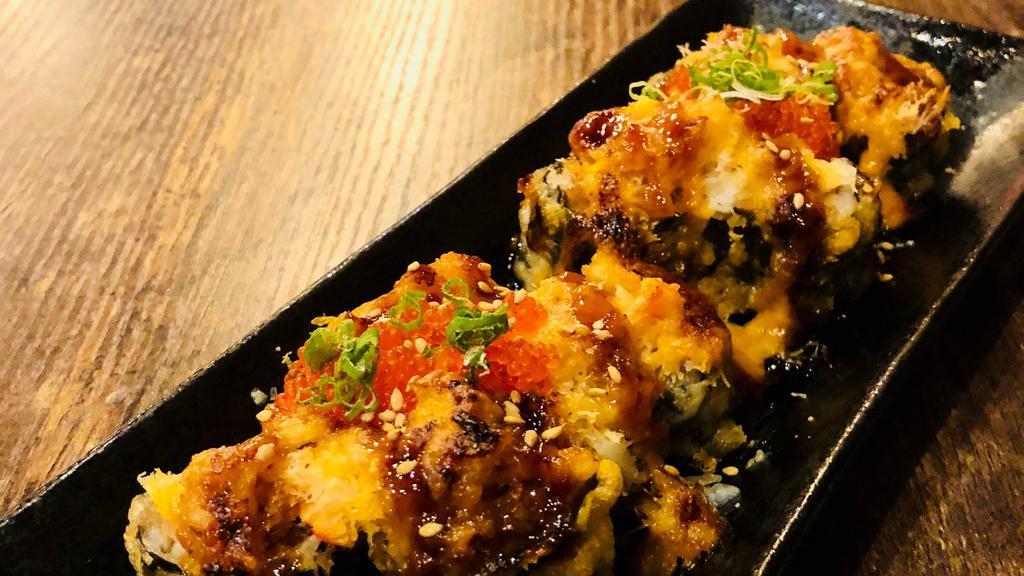 Volcano Roll · Deep Fried Tuna Maki Topped with Baked Snow Crab Meat, Spicy Aioli, Soy Glaze, Cheese and Tobiko, Scallions.