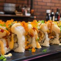 Lemon Drop Roll · Shrimp Tempura, Imitation Crab Meat Topped with Scallop and Sliced Lemons and Tobiko.