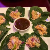 Miang Kum · Vegetarian. Wrapped in spinach leaf each bite contains roasted sweet coconut, sliced lime, r...