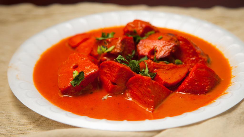 Chicken Tikka Masala · Boneless cubes of chicken marinated and cooked in tandoor simmered in tomato sauce and spices. Served with basmati rice.