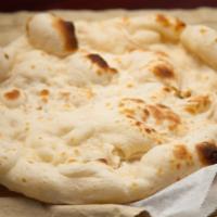 Naan · White flour bread cooked in clay oven tandoor.