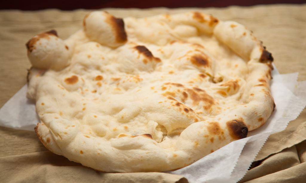 Plain Naan · A traditional Indian flat bread made w/refined flour & baked in a tandoor oven.