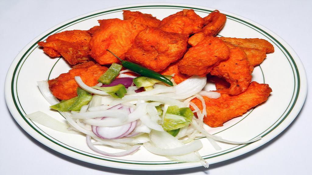 Fish 65 · Very crispy boneless fish fried with a touch of exotic spices.
