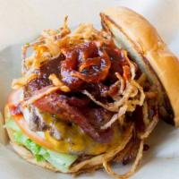 The John Wayne Burger · Homemade BBQ sauce, onion hay stacks, Cheddar, bacon, lettuce, tomato, onion and mayo.