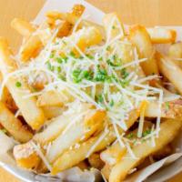Truffle Fries · Tossed in white truffle oil and Grana Padano, Chives.