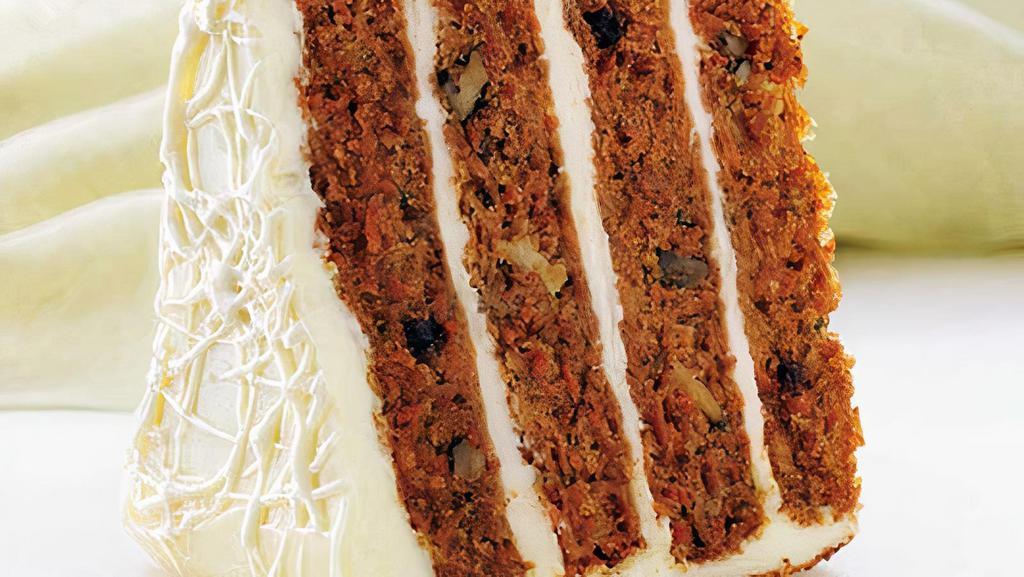 Carrot Cake · Vegetarian. Four layers of moist carrot cake filled with raisins, walnuts, and pineapple, topped with a smooth cream cheese frosting.