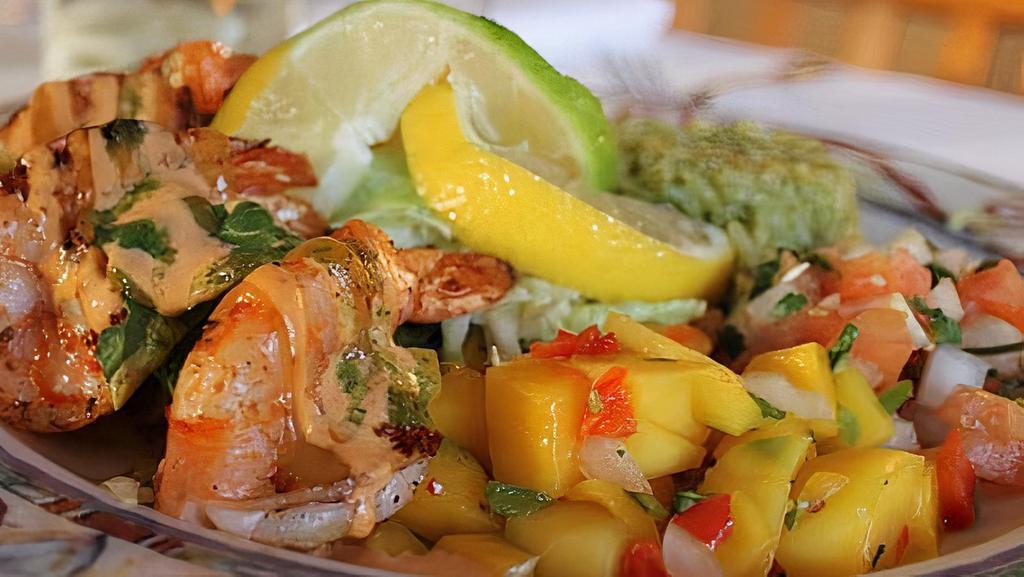 Shrimp Tostada · Shrimp, topped with coleslaw, tomatillo sauce, sour cream, guacamole and mango salsa.
