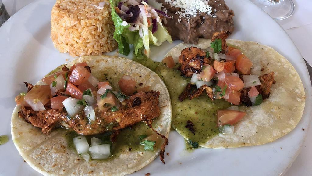 Taco · Choice of chicken, al pastor or chile verde, topped with salsa, onions cilantro and served with rice and beans.