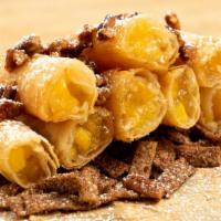 Peach Mango Cobbler · Caramelized Peach and Mango pie filling then wrapped up and fried to a golden crispy perfect...