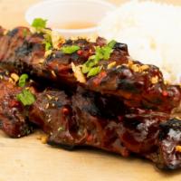BBQ Chicken Rice Plate · Skewered and grilled BBQ chicken thighs basted with our in-house sauce and served with 2 sco...