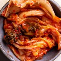 Kimchi · House made marinated, spicy, Napa cabbage.