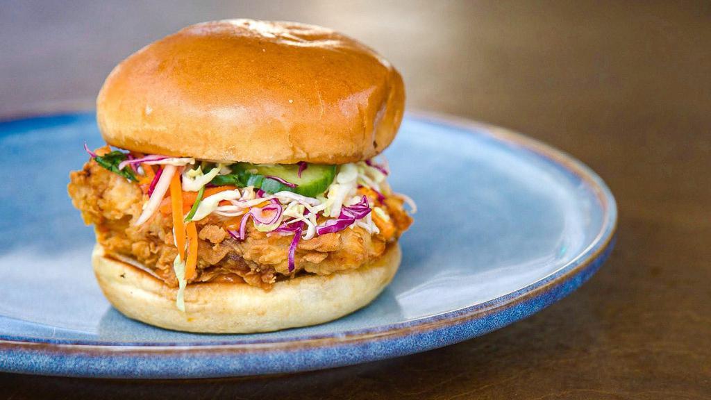 Fried Chicken Sando · Our very own crispy fried chicken sandwich with papaya-cucumber slaw and Mohinga mayo (lemongrass, ginger, turmeric) on a buttery, soft brioche bun.
