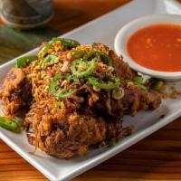 Salt and Pepper Wings · Deep-fried, tossed with salt & pepper, fried garlic, and jalapeños. Served with our house ch...