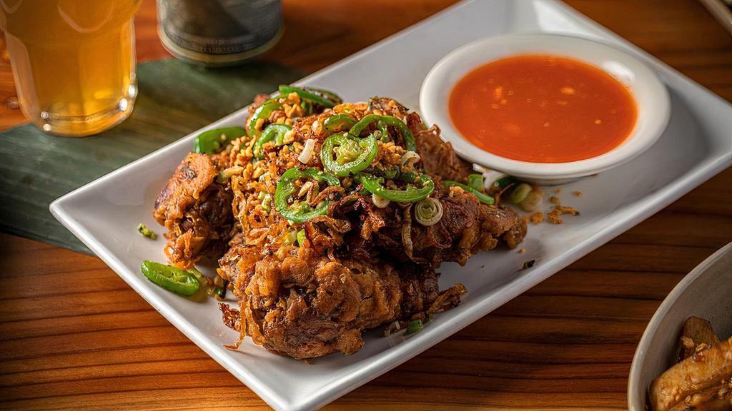 Salt and Pepper Wings · Deep-fried, tossed with salt & pepper, fried garlic, and jalapeños. Served with our house chili sauce.