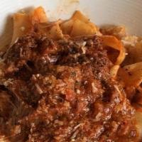Coda Alla Vaccinara · Homemade pappardelle pasta served with slowly braised Oxtail ragu in tomato sauce and Pecori...