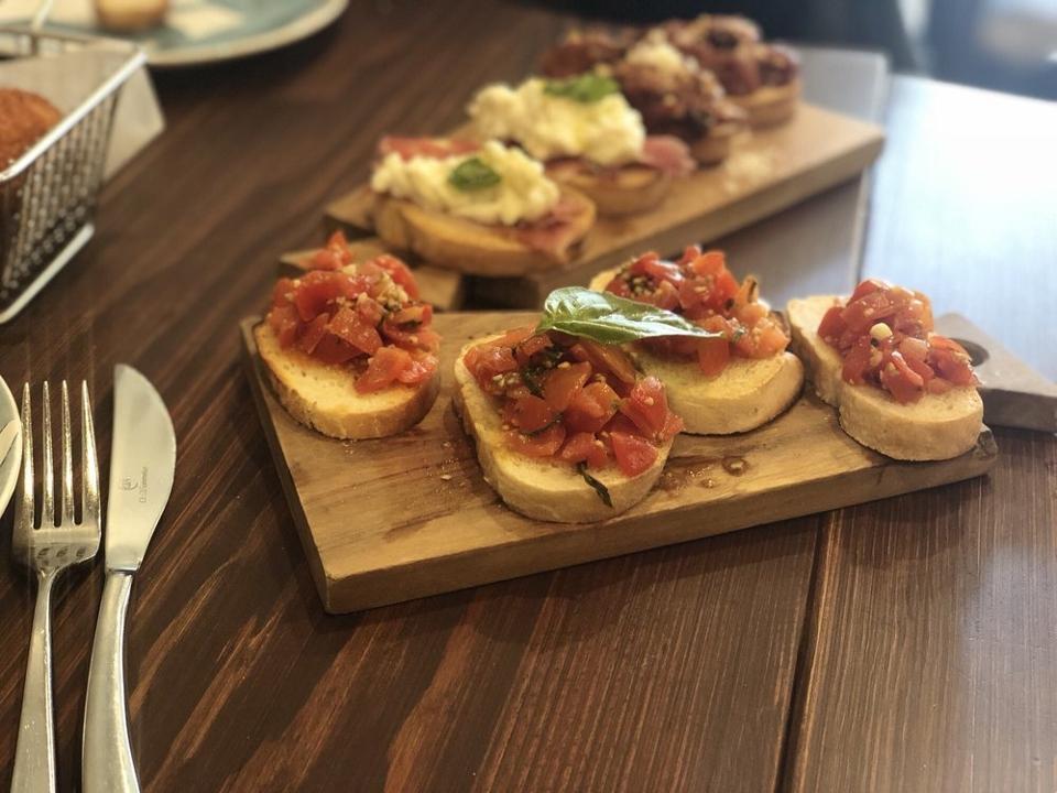 Bruschetta · Toasted housemade bread served with choice of : seasonal tomatoes with basil  or Fresh burrata cheese and prosciutto di Parma