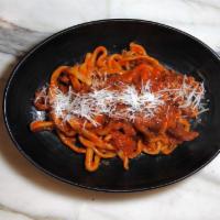 Amatriciana · Housemate bucatini pasta served with Guanciale, onions, mild spicy tomato sauce & Pecorino R...
