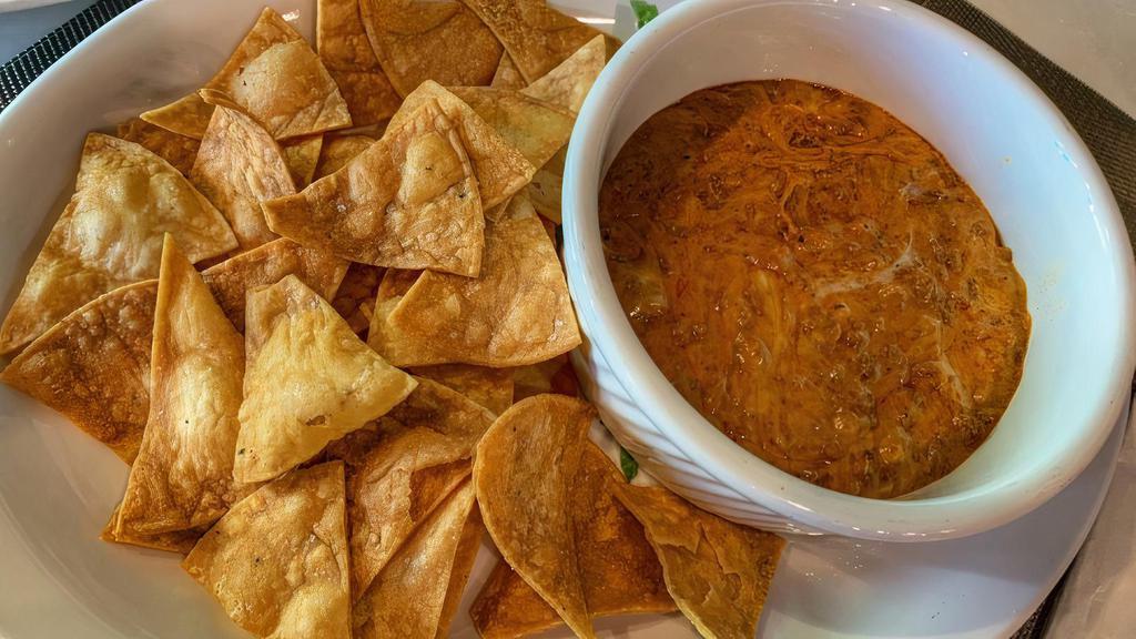 Chorizo Bean Dip · Our fresh home-made chorizo, on top of delicious home-made re-fried beans, with melted cheese flowing all around.