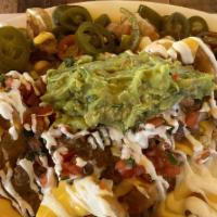 Mega Fuego Nachos - Fries · For 2-4 people appetizer or big dinner. Crispy home-made tortilla chips, melted cheese on to...
