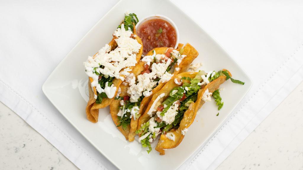 Crispy Tacos Dorados · 3 crunchy tacos stuffed with choice of cheese and potatoes, carnitas, chorizo or shredded Mexican style chicken and then finished with shredded lettuce, salsa, sourcream and queso fresco.