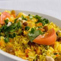 Rice Pulao · Saffron flavored basmati rice garnished with peas.