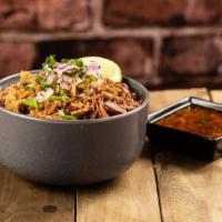 Birria Bowl · Consomme infused rice bowl topped with beef brisket birria, diced onions, cilantro and monte...