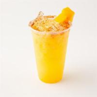Mango Lemonade · Silky sweet mango infused lemonade topped with tajin and mango bits. Served chilled with ice.