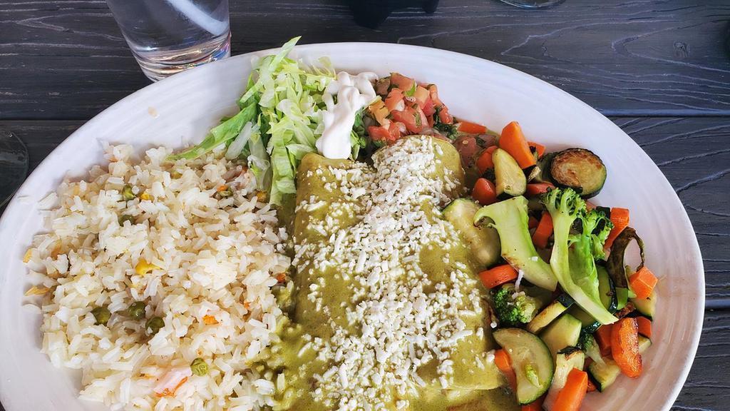 Seafood Enchiladas · Two enchiladas filled with shrimp and crab, monterey jack cheese, grilled corn, covered with a creamy tequila sauce. Served with rice and vegetables.