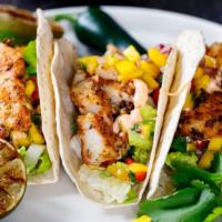 Sonora Fish Tacos · Two tasted tacos perfectly filled with grilled fish, fresh lettuce, tomatoes, Sonora sauce a...