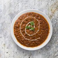 Creamy Black Dal  · Slow-cooked mixed black lentil, tempered with tomatoes, onions, butter, Indian spices and fi...