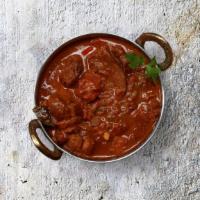 Capital Lamb Curry · Tender chunks of lamb simmered in brown onion and tomato curry, seasoned with fresh herbs an...