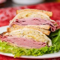 Reuben Sandwich · Corned beef, swiss, and sauerkraut. Includes mustard, mayonnaise, lettuce, tomato, pickles, ...